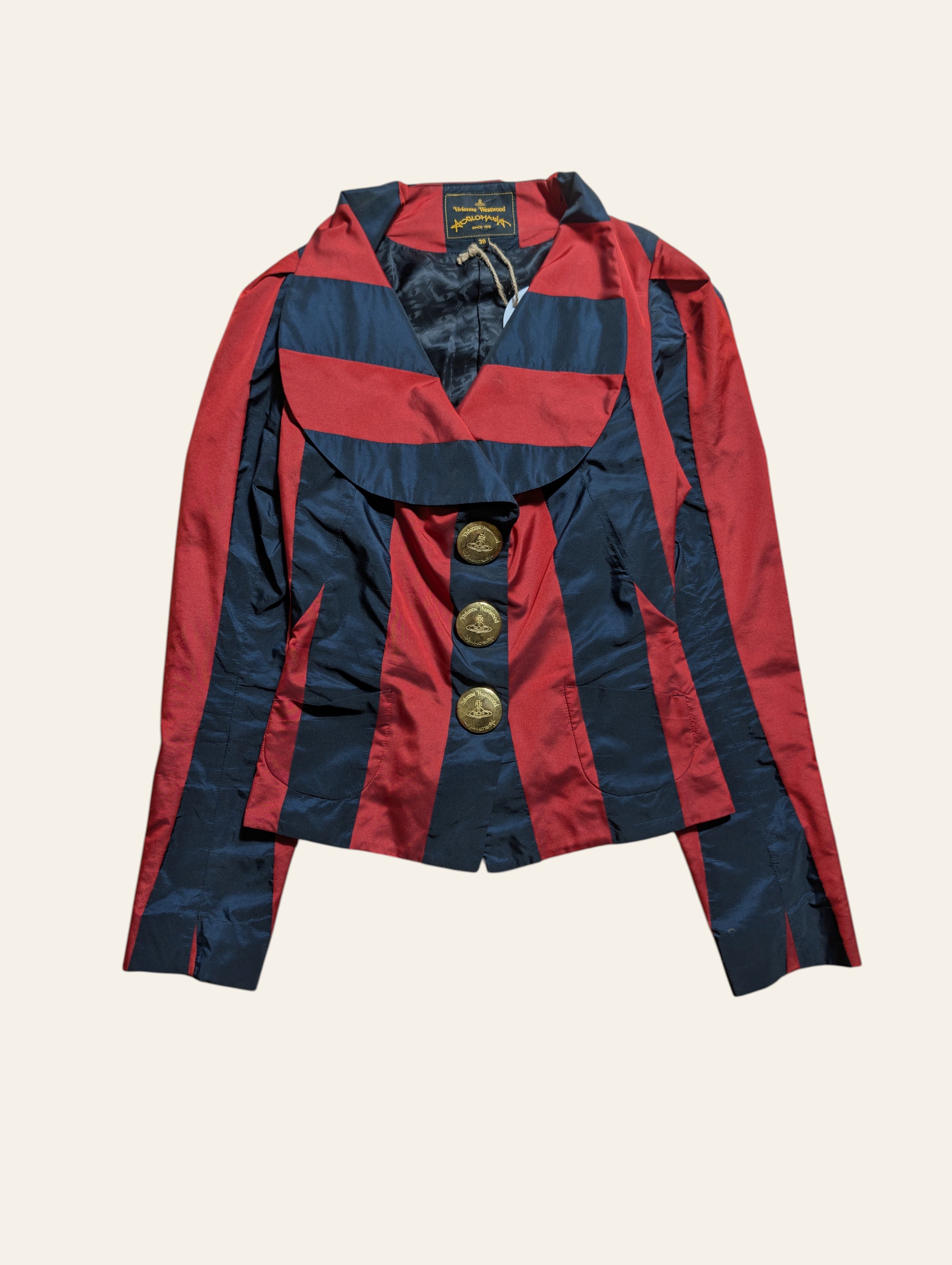 A red and navy blue striped jacket with gold buttons, laid flat against a light beige background.
