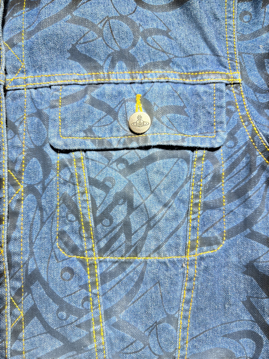 Vivienne Westwood denim jacket featuring a black graphic print and contrast yellow stitching
