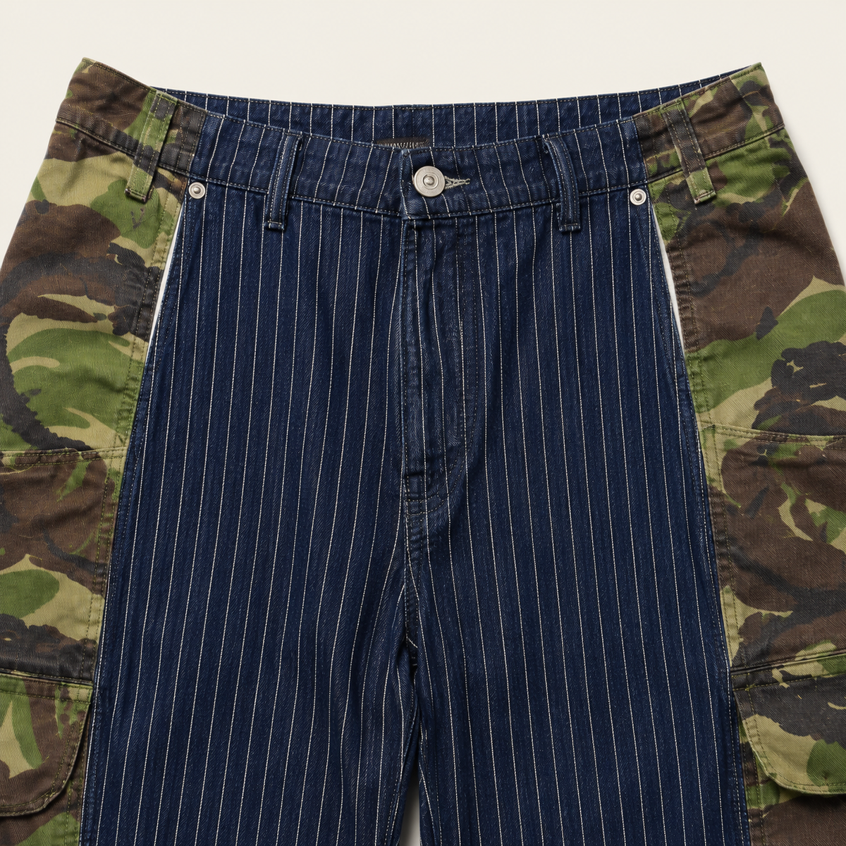 Close-up of central pinstripe jeans with woodland camouflage outer panels