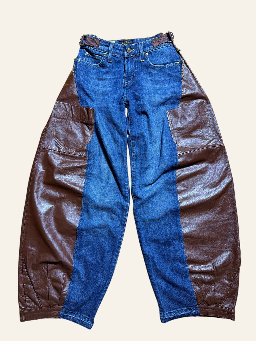 Lolly and Lotus reworked blue denim jeans with brown leather side panels and an integrated waist belt.