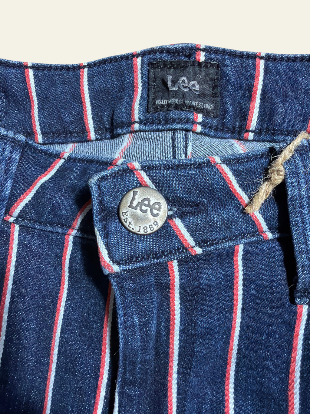 Lolly and Lotus reworked Lee x Army jeans in dark blue denim with vertical red and white pinstripes and metal button