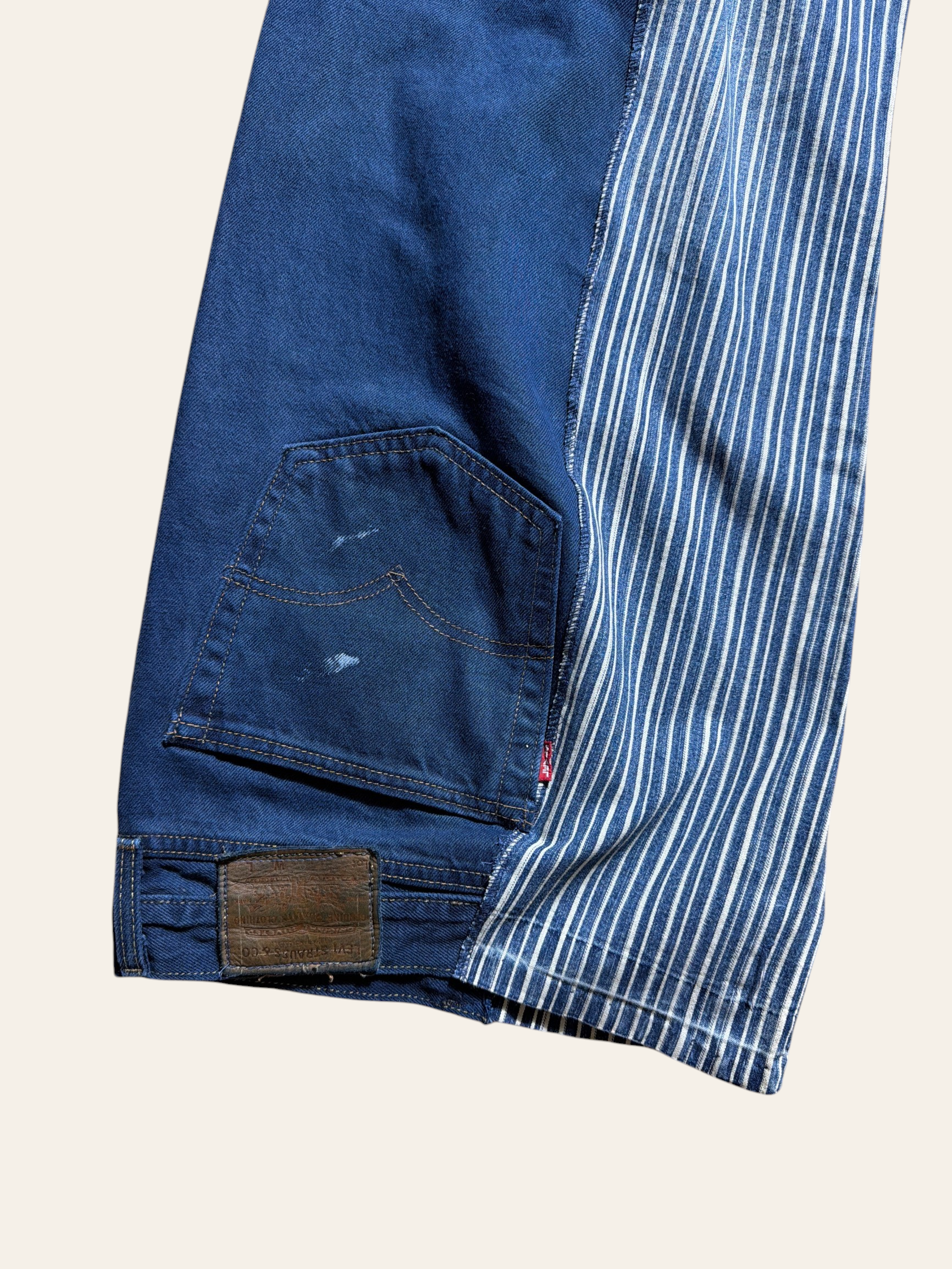Lolly and Lotus reworked vintage Levi denim jeans featuring a blue and white striped panel and back pocket detail.