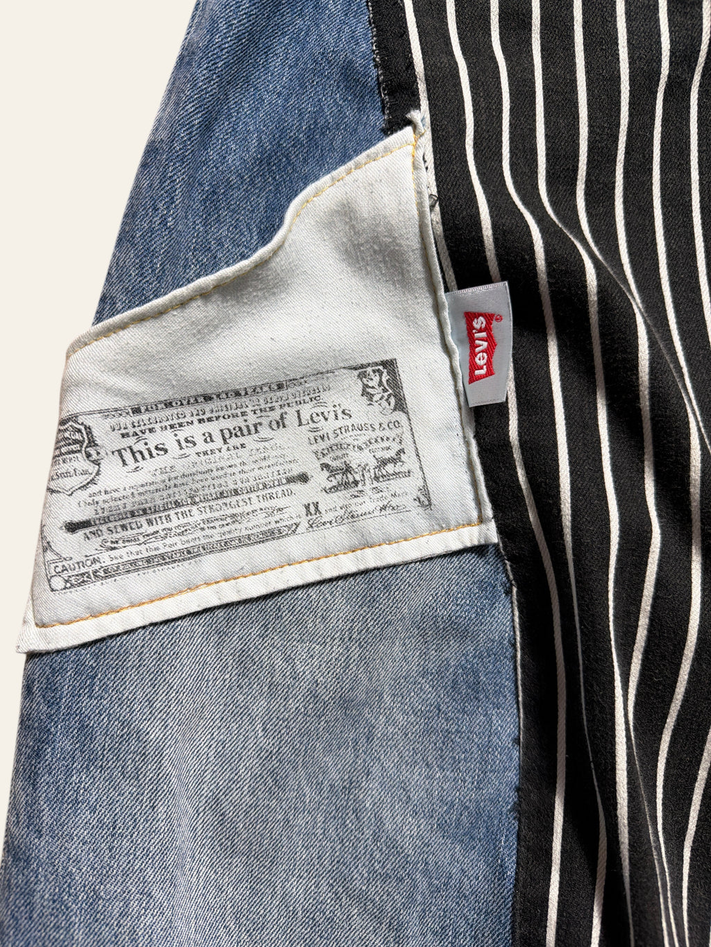 Lolly and Lotus reworked Levi x Ralph Lauren jeans featuring blue denim and black and white striped fabric details.