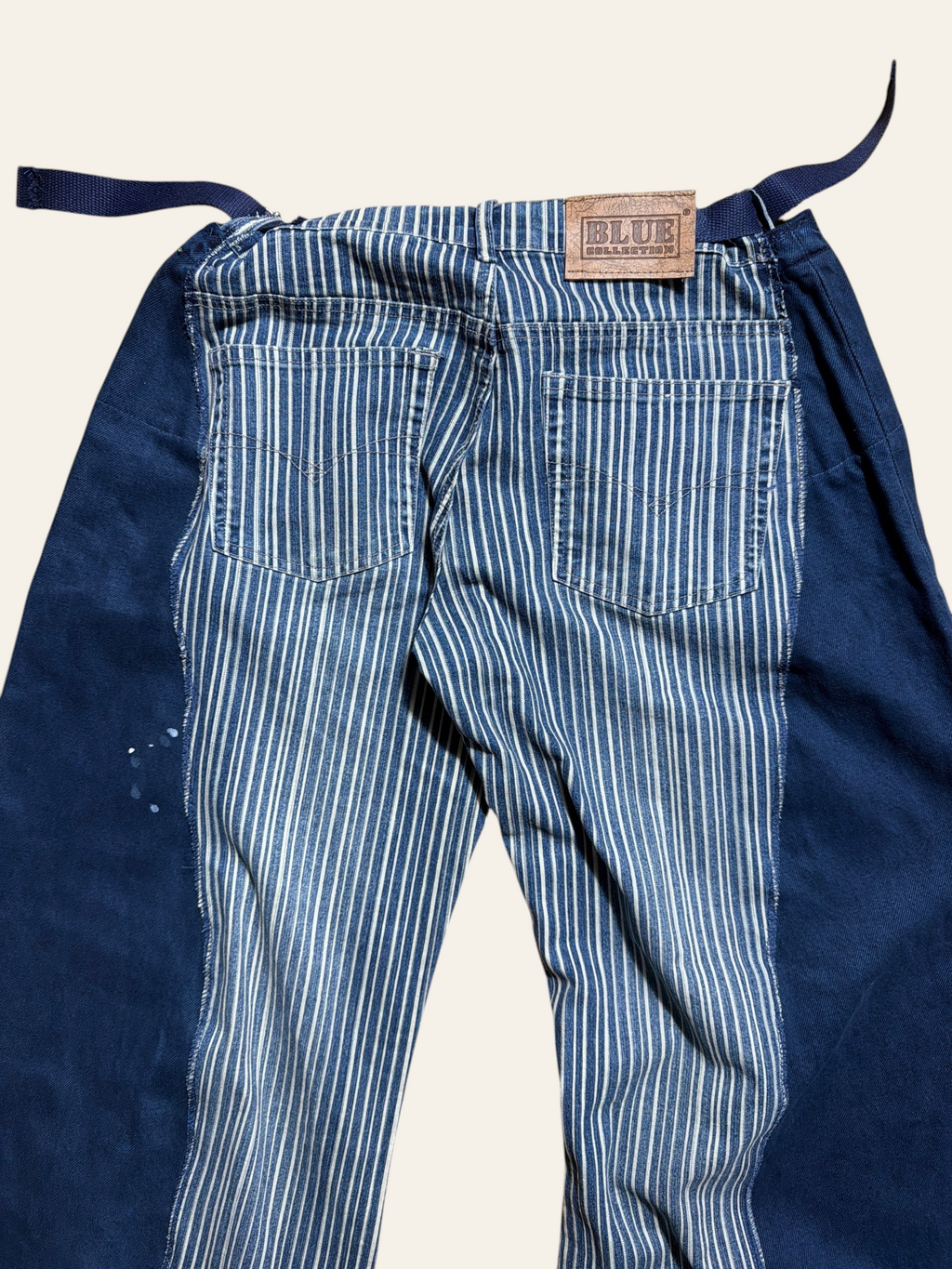 Lolly and Lotus reworked vintage Levi denim jeans featuring a blue and white striped pattern with solid blue panels.