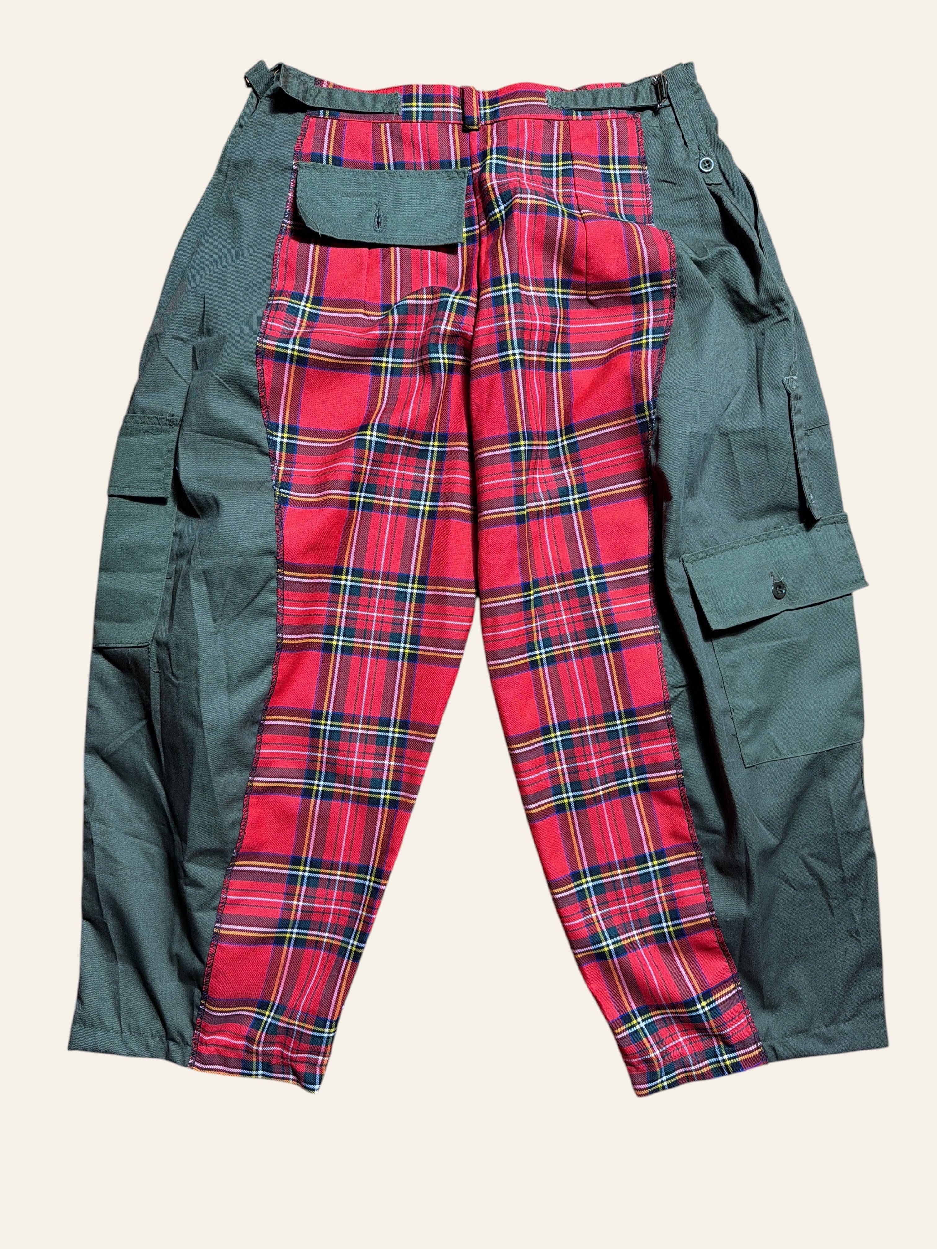 Lolly and Lotus reworked army pants featuring red tartan panels and olive green cargo pockets on a wooden floor.