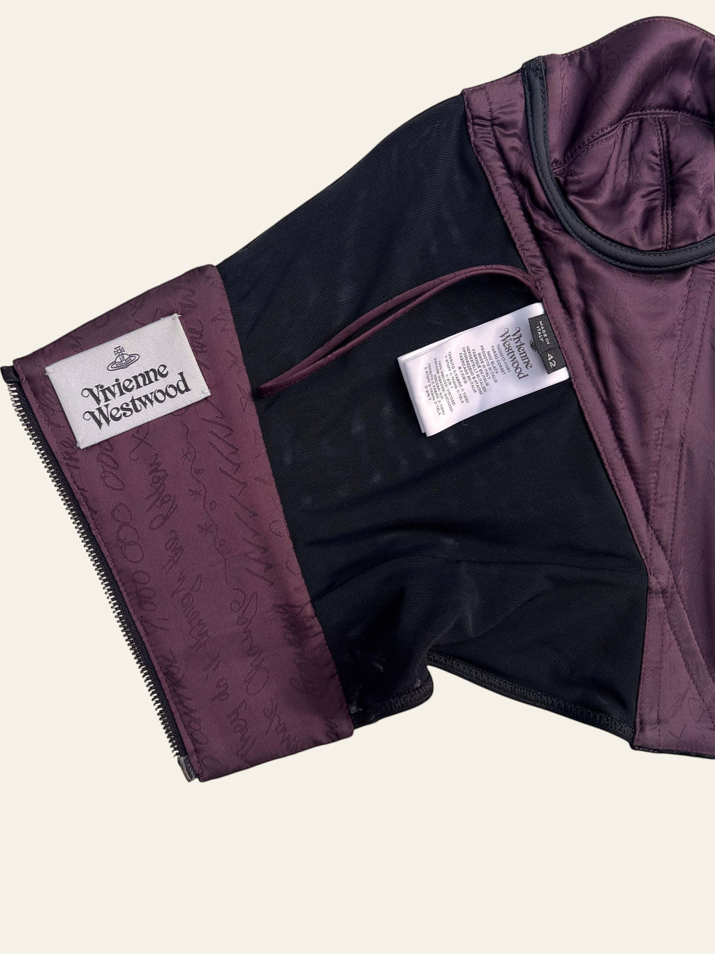 Lolly and Lotus Vivienne Westwood corset interior showing purple lining, brand label, and care tag details.