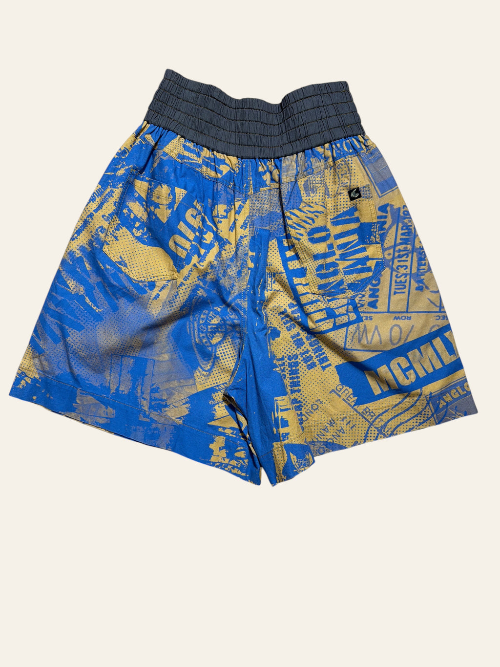 Lolly and Lotus Vivienne Westwood Anglomania blue and yellow graphic print shorts with a wide grey elastic waistband.