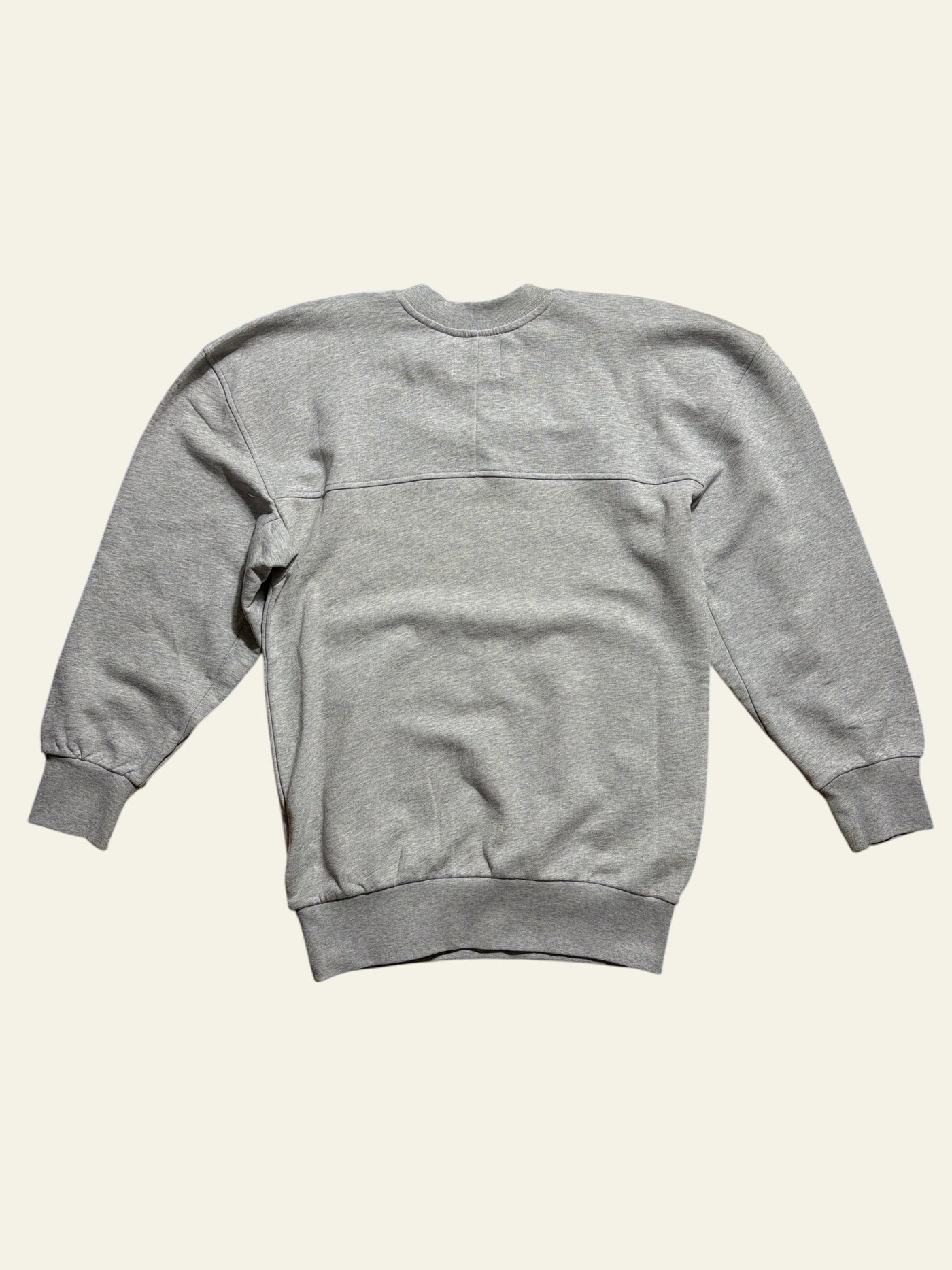Back view of a grey Lolly and Lotus Vivienne Westwood Sunken Sander oversized sweatshirt on a wooden floor.