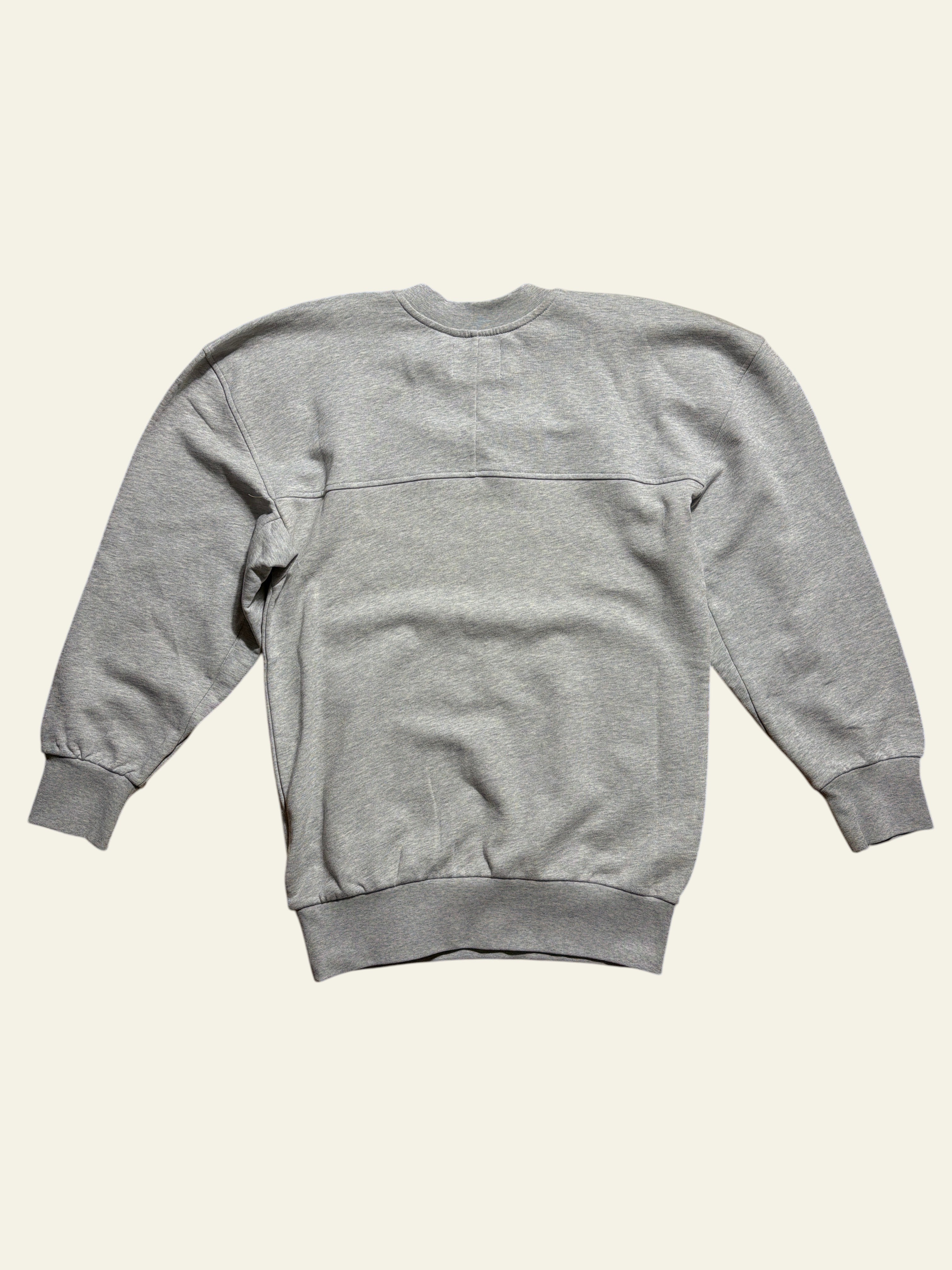 Back view of a grey Lolly and Lotus Vivienne Westwood Sunken Sander oversized sweatshirt on a wooden floor.