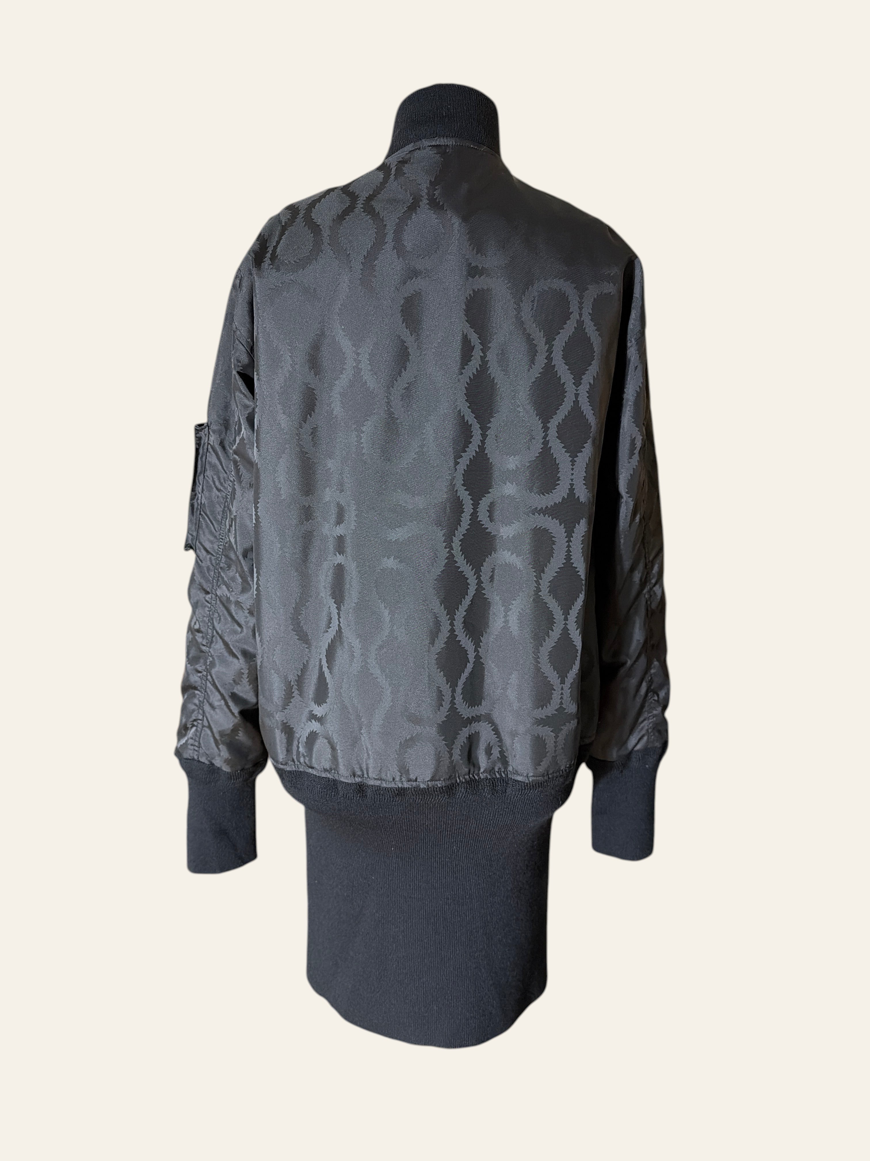 Lolly and Lotus Vivienne Westwood MAN black tonal jacquard longline bomber jacket with extended ribbed hem, back view.
