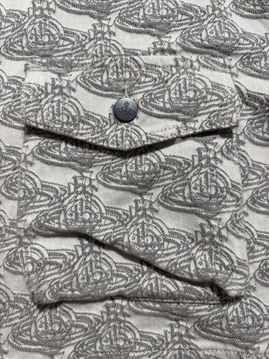 Lolly and Lotus Vivienne Westwood denim jacket featuring a grey and white all-over Orb logo print and button pocket.