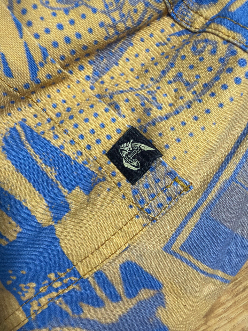 Lolly and Lotus Vivienne Westwood Anglomania shirt featuring a blue and yellow graphic print with a signature orb tab