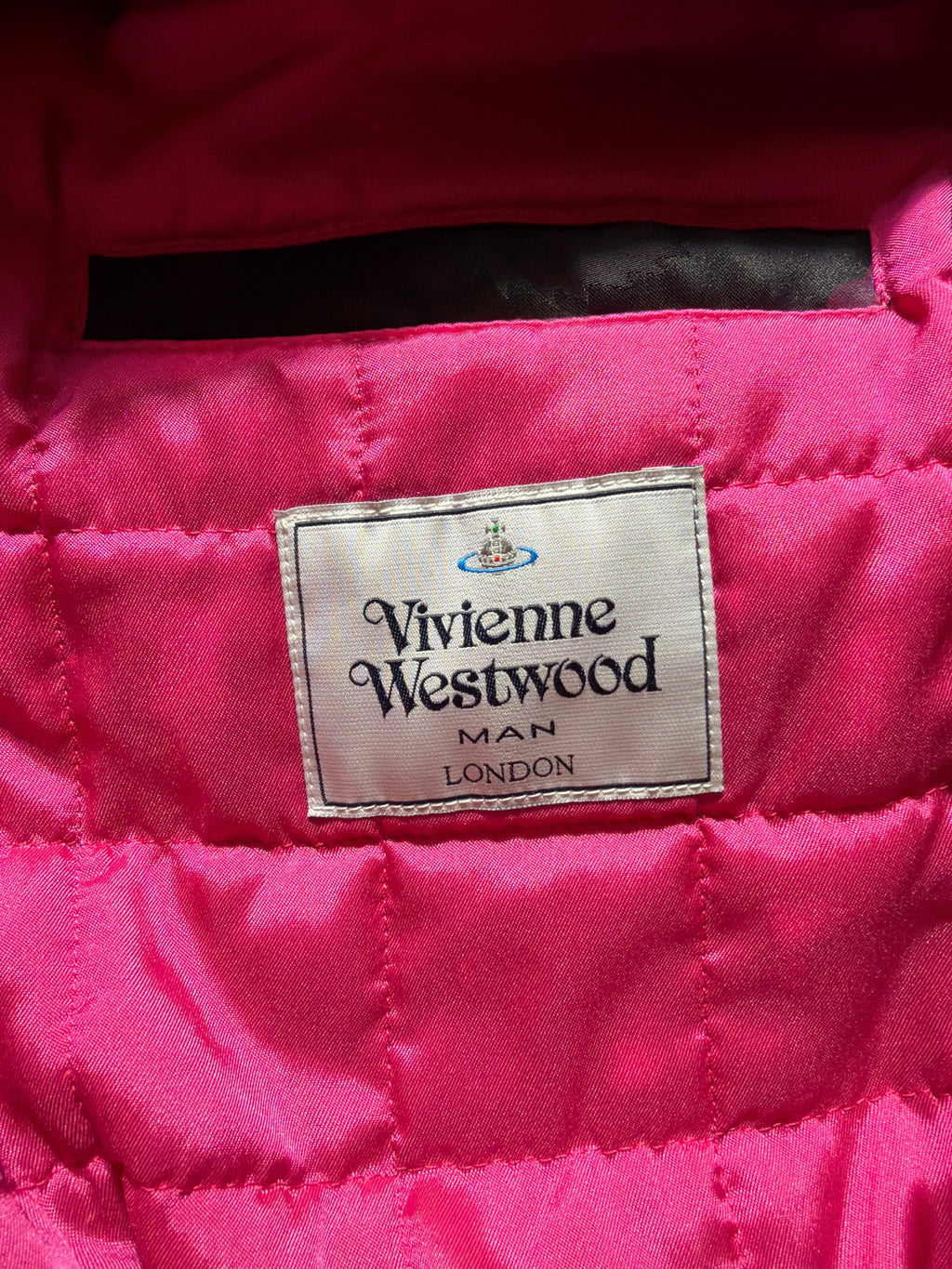 Lolly and Lotus Vivienne Westwood MAN label on a vibrant hot pink quilted bomber jacket lining