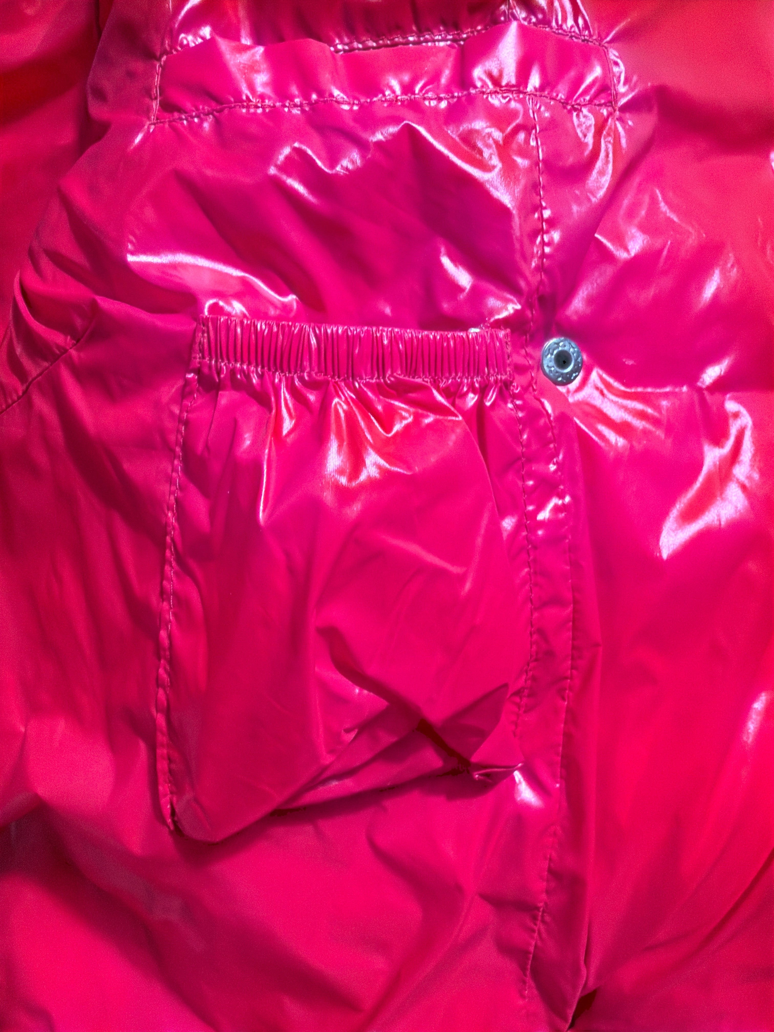 Lolly and Lotus Vivienne Westwood puffer jacket in glossy bright pink with a gathered pocket and snap button detail.