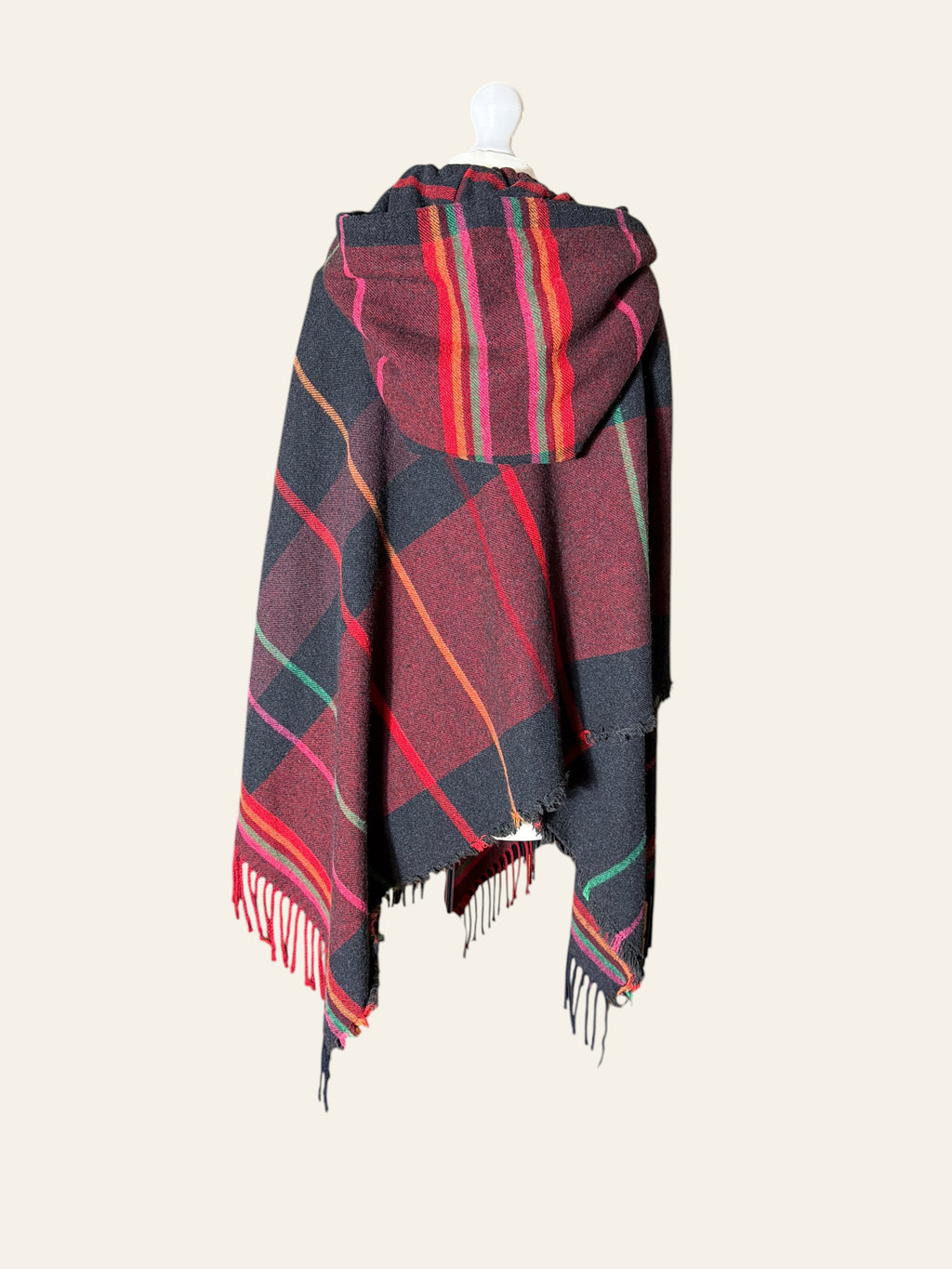 Lolly and Lotus Vivienne Westwood hooded tartan poncho in burgundy, black, and red with fringe hem on a mannequin