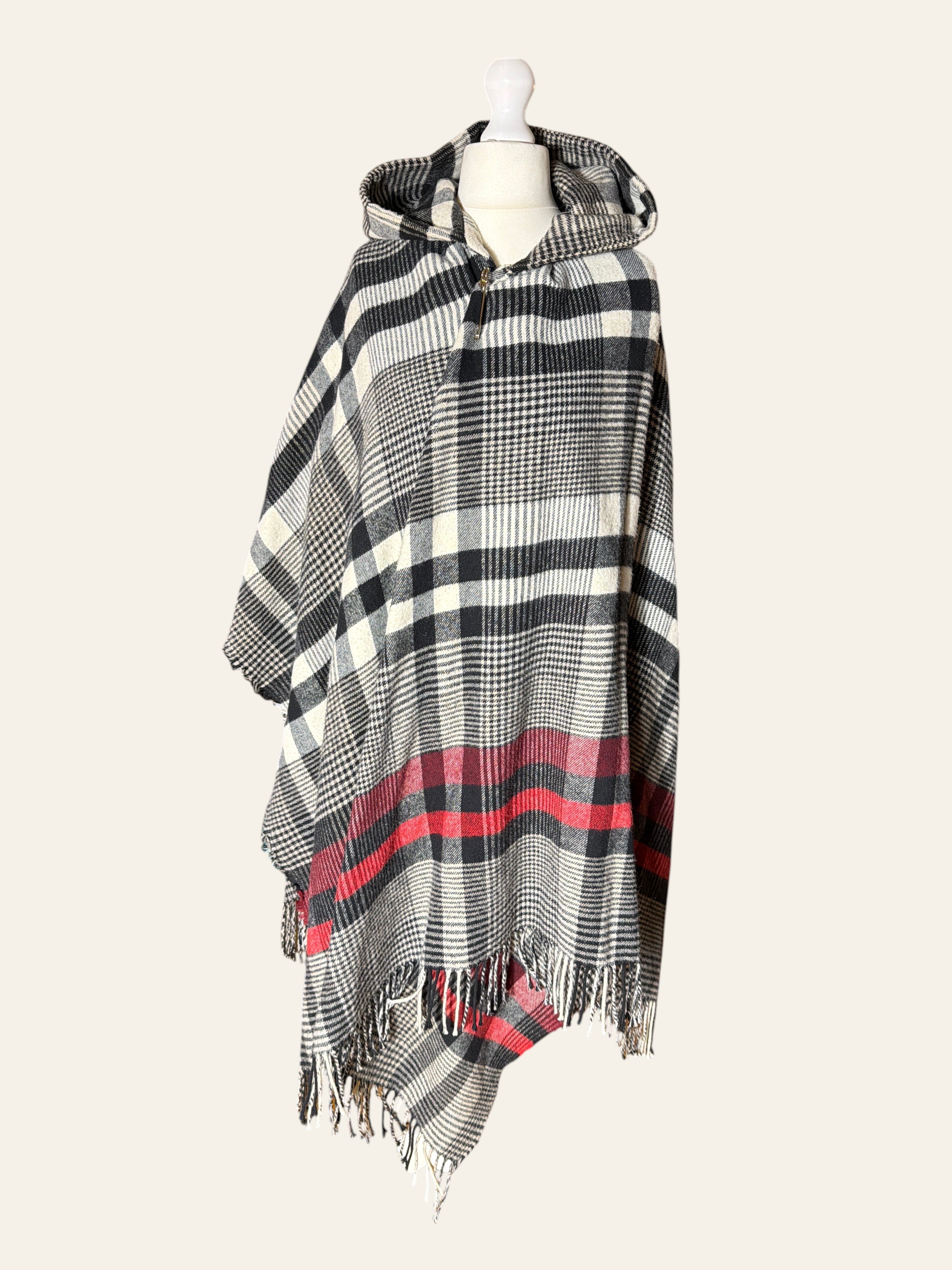 Lolly and Lotus Vivienne Westwood hooded poncho in black, cream, and red tartan with fringed edges on a mannequin.