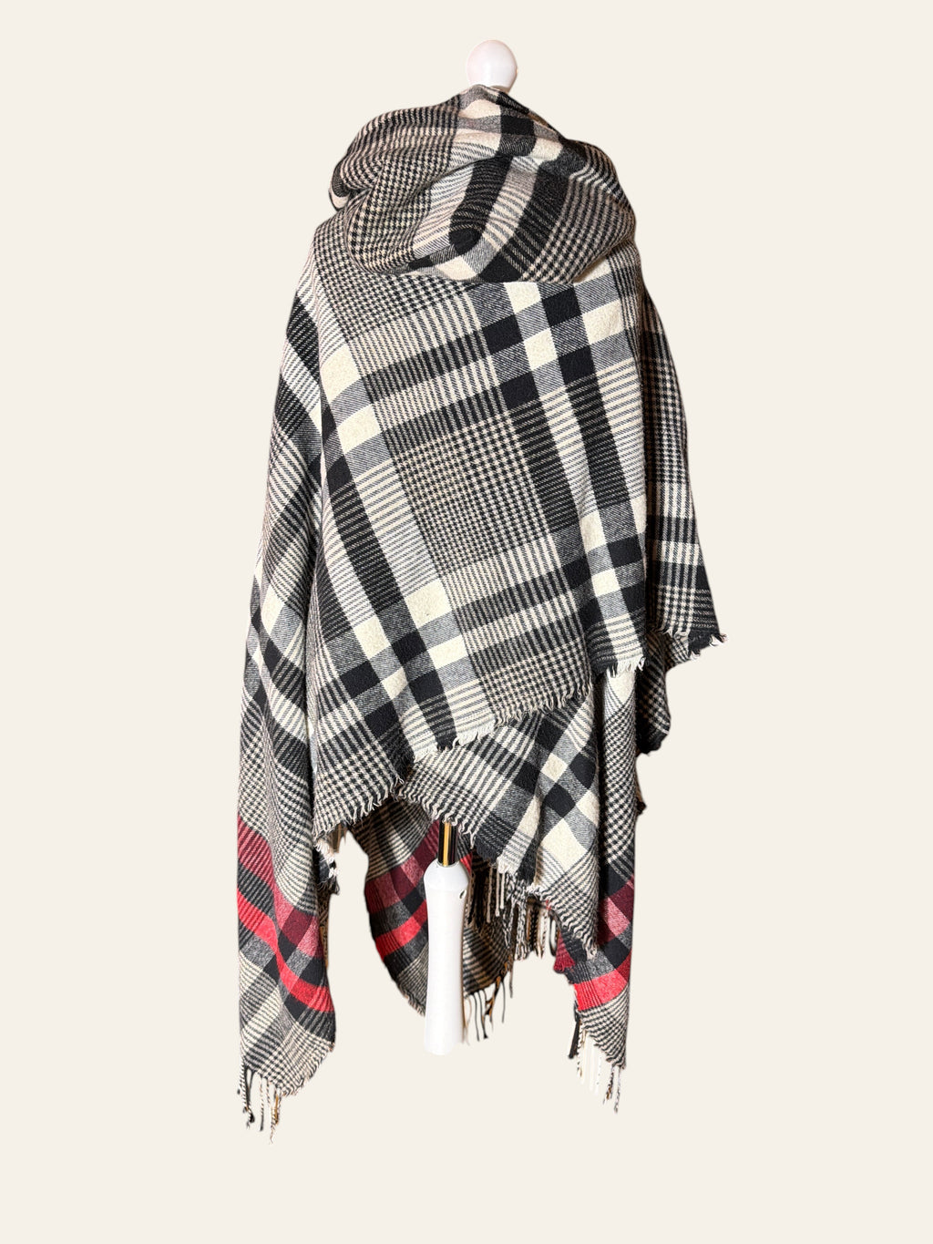 Lolly and Lotus Vivienne Westwood hooded poncho in black, cream, and red tartan with fringed edges on a mannequin