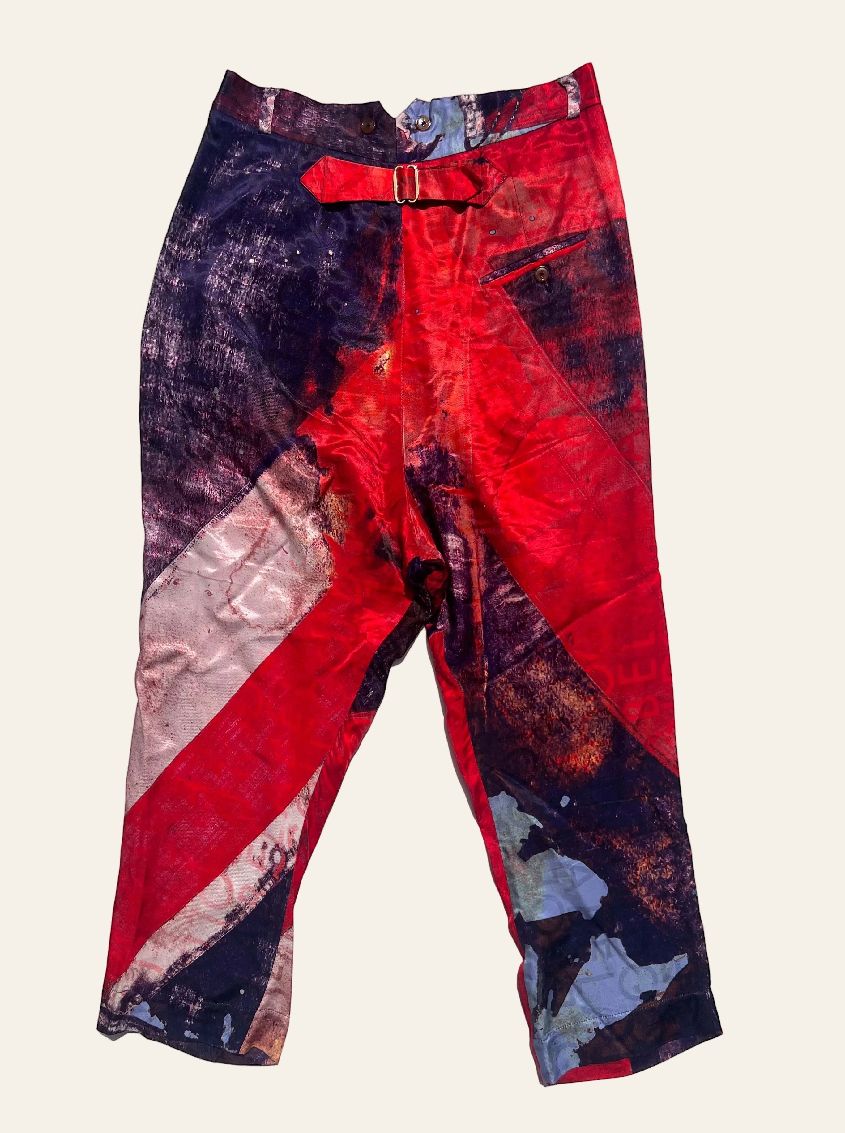 Lolly and Lotus Vivienne Westwood trousers featuring an abstract Union Jack print in red, purple, and blue with a buckle