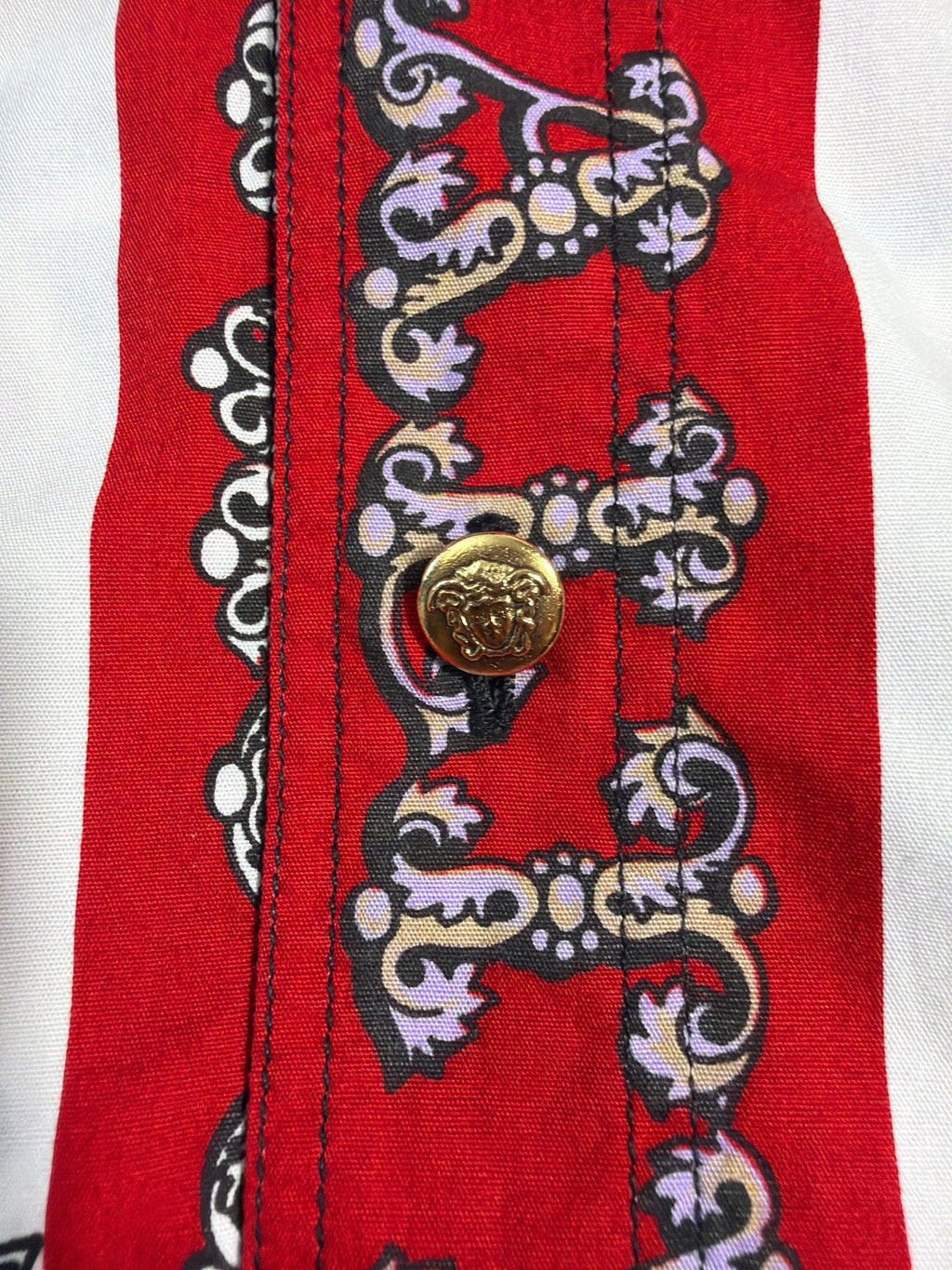 vintage Versace dress shirt featuring a red and white print with a gold-tone Medusa head button.