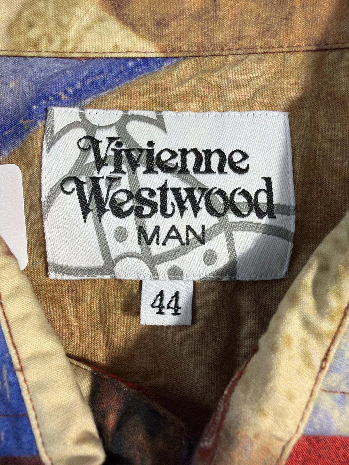 Vivienne Westwood MAN shirt label with size 44 tag on a multicoloured abstract print cotton fabric.
