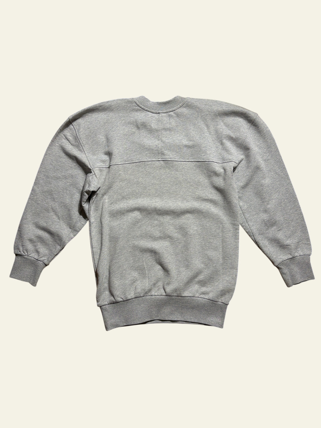 Back view of a grey Vivienne Westwood Sunken Sander oversized sweatshirt on a wooden floor.