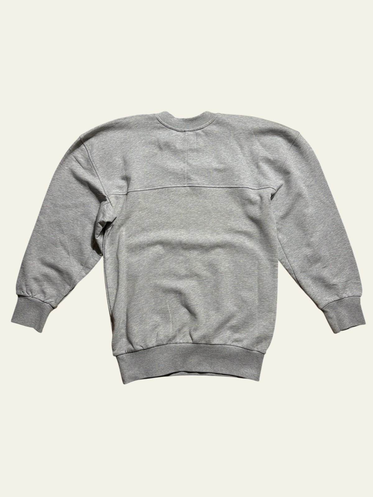 Back view of a grey Vivienne Westwood Sunken Sander oversized sweatshirt on a wooden floor.