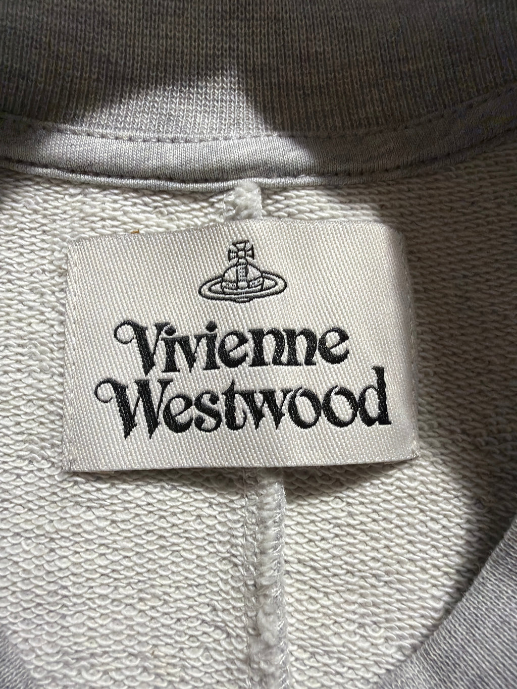 Vivienne Westwood Sunken Sander sweatshirt interior brand label and grey cotton fabric detail.