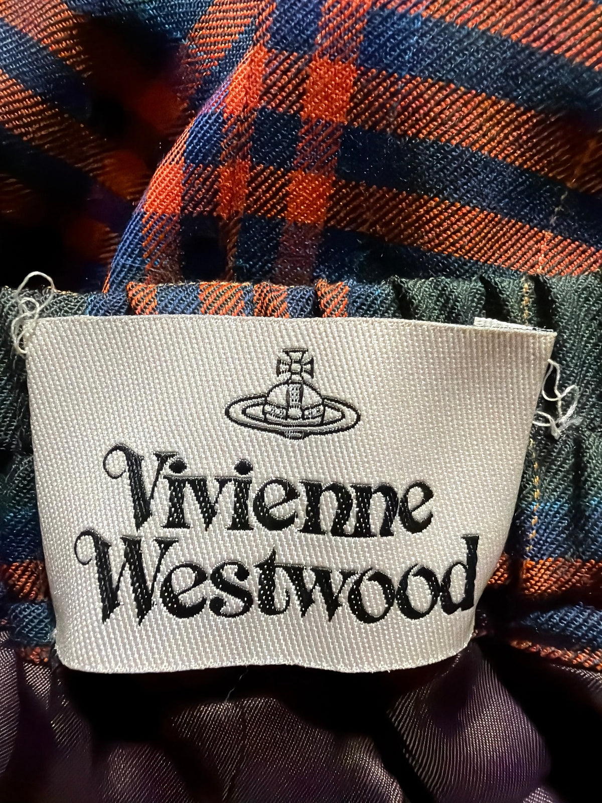 Vivienne Westwood tartan wool skirt label detail in red, blue, and green plaid pattern.